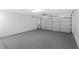 A garage with a white painted block wall and gray sealed concrete flooring at 400 Timbercreek N Dr, Winter Garden, FL 34787