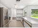Bright kitchen with stainless steel appliances and tile flooring at 400 Timbercreek N Dr, Winter Garden, FL 34787