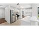 Bright, all-white kitchen with stainless steel appliances and modern fixtures at 400 Timbercreek N Dr, Winter Garden, FL 34787