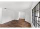 Bright, open room with wood floors, white walls, trim, and a large window bringing in light at 400 Timbercreek N Dr, Winter Garden, FL 34787