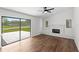 Bright living room with fireplace, hardwood floors, and sliding glass doors to the backyard at 400 Timbercreek N Dr, Winter Garden, FL 34787