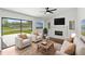 Bright living room with modern furniture, fireplace, and expansive sliding glass doors at 400 Timbercreek N Dr, Winter Garden, FL 34787