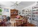 Bright dining room with large table, ceiling fan, and built-in shelves at 414 W 19Th St, Sanford, FL 32771