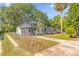 Exterior view of the home with driveway, chain-link fence and backyard at 414 W 19Th St, Sanford, FL 32771