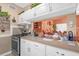 Well-equipped kitchen with white cabinets, gas range, and convenient pass-through to the living room at 414 W 19Th St, Sanford, FL 32771