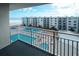 Balcony view of pools at condo complex with beach nearby and sunny blue skies above at 4151 S Atlantic Ave # 5110, New Smyrna Beach, FL 32169
