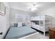 Bright bedroom featuring a bunk bed, full bed, ceiling fan, and a window at 4151 S Atlantic Ave # 5110, New Smyrna Beach, FL 32169
