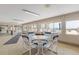 Shared indoor common area featuring tables, chairs, and views of the pool and condominium complex at 4151 S Atlantic Ave # 5110, New Smyrna Beach, FL 32169