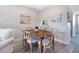 Charming dining area with wood table and seating for six at 4151 S Atlantic Ave # 5110, New Smyrna Beach, FL 32169