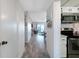 Hallway leading to living area with plank floors, kitchen area, and neutral walls at 4151 S Atlantic Ave # 5110, New Smyrna Beach, FL 32169
