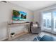 Bright living room with TV, console table, sliding door, accent chairs, and plush gray recliner at 4151 S Atlantic Ave # 5110, New Smyrna Beach, FL 32169