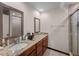 Bathroom featuring double sinks, granite countertops, and tile shower at 5310 Pebble Beach Dr # F, Orlando, FL 32811