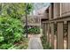 Inviting home exterior featuring a private entry deck surrounded by lush landscaping at 5310 Pebble Beach Dr # F, Orlando, FL 32811