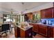 Kitchen with stainless steel appliances, island, and granite countertops at 5310 Pebble Beach Dr # F, Orlando, FL 32811