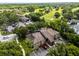 Aerial view showcases the property, surrounding trees, the golf course, and ample parking at 538 W Par St # 538, Orlando, FL 32804