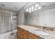 Bathroom features a glass-enclosed shower, granite countertop and wooden cabinets at 538 W Par St # 538, Orlando, FL 32804