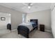 This bedroom is decorated with an area rug and a black wooden bed frame and ceiling fan at 538 W Par St # 538, Orlando, FL 32804