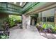 Courtyard featuring lush tropical landscaping, a brick accent wall, and walkways to the units at 538 W Par St # 538, Orlando, FL 32804