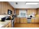 Well-equipped kitchen features granite countertops, stainless steel appliances, and ample cabinetry, enhanced by hardwood floors at 538 W Par St # 538, Orlando, FL 32804