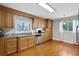 Well-lit kitchen with granite counters, stainless steel appliances, and natural light with windows and hardwood floors at 538 W Par St # 538, Orlando, FL 32804