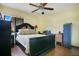A bedroom featuring dark furniture, wood floors, and a ceiling fan at 545 Mystic Wood St, Casselberry, FL 32707