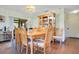 A dining room featuring a wooden table and chairs, with a cabinet displayed against an off-white wall at 545 Mystic Wood St, Casselberry, FL 32707
