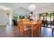 Open concept dining room with natural wood table and chairs, with sliding doors to the lanai at 545 Mystic Wood St, Casselberry, FL 32707