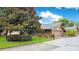 Charming home featuring a well-maintained lawn, driveway, and mature tree at 545 Mystic Wood St, Casselberry, FL 32707