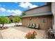 Exterior patio area with brick pavers, seating, and a view of palm trees at 545 Mystic Wood St, Casselberry, FL 32707