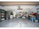 Spacious garage with gray epoxy floors, ample storage, and overhead lighting for functionality at 545 Mystic Wood St, Casselberry, FL 32707