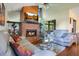 Cozy living room featuring a brick fireplace, wood paneling, and comfortable seating at 545 Mystic Wood St, Casselberry, FL 32707