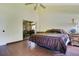 A main bedroom showcasing wood floors and a sliding door leading to an enclosed porch at 545 Mystic Wood St, Casselberry, FL 32707