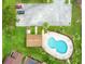 Aerial view of kidney shaped pool, pool house and lush landscaping at 545 Mystic Wood St, Casselberry, FL 32707