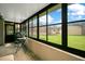 Enclosed sunroom featuring brick floors, and large windows with a lush lawn view at 545 Mystic Wood St, Casselberry, FL 32707