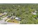 Aerial view of the home surrounded by lush trees and neighboring houses at 606 Washington St, Daytona Beach, FL 32114