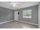 Bright bedroom features wood-look floors, a ceiling fan and two windows for natural light at 606 Washington St, Daytona Beach, FL 32114