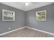 Cozy bedroom featuring wood-look floors, and ample natural light from the windows at 606 Washington St, Daytona Beach, FL 32114