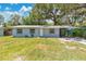 Charming single-story home featuring a cozy carport and a well-maintained front lawn at 606 Washington St, Daytona Beach, FL 32114
