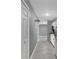 Long hallway featuring gray walls, recessed lighting and new tile floors at 606 Washington St, Daytona Beach, FL 32114