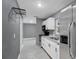Contemporary kitchen boasting stainless steel appliances and sleek, white cabinetry at 606 Washington St, Daytona Beach, FL 32114