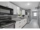Modern kitchen featuring white cabinets, stainless steel appliances, and stylish granite countertops at 606 Washington St, Daytona Beach, FL 32114