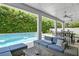 Outdoor patio with blue lounge chairs overlooking the sparkling pool and lush greenery at 617 Worthington Dr, Winter Park, FL 32789
