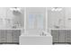 A modern bathroom features a soaking tub, dual sinks, and bright lighting at 617 Worthington Dr, Winter Park, FL 32789