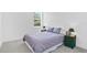 Cozy bedroom with plush carpeting, a charming window, and bedside tables with lamps at 617 Worthington Dr, Winter Park, FL 32789