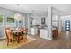 Elegant dining area connected to a modern kitchen with an island and stainless steel appliances at 617 Worthington Dr, Winter Park, FL 32789