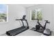 Bright exercise room with treadmill, stationary bike, and natural light at 617 Worthington Dr, Winter Park, FL 32789