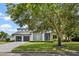 Modern two story home with a three car garage, beautiful trees, and landscaping at 617 Worthington Dr, Winter Park, FL 32789