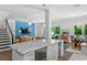 Open concept kitchen features a large island with modern appliances adjacent to the living and dining areas at 617 Worthington Dr, Winter Park, FL 32789