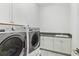 Convenient laundry room with modern machines, ample counter space, and storage cabinets at 617 Worthington Dr, Winter Park, FL 32789