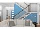 Cozy living room featuring blue wall, hardwood floors and stairs, plus comfortable sofa at 617 Worthington Dr, Winter Park, FL 32789